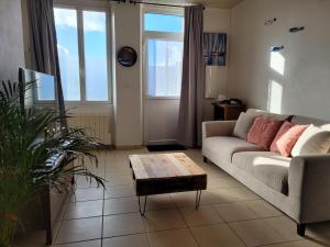 a living room with a couch and a coffee table at Petite maison proche mer - Flamanville in Flamanville +21 photos