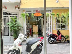 two motorcycles parked in front of a store at Coco Homestay in Ho Chi Minh City