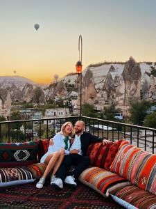 a man and a woman sitting on a couch at Bedrock Cave Hotel in Göreme