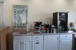 a kitchen with a counter with a coffee maker at American Host Inn in Hart