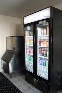 a refrigerator with its door open in a store at American Host Inn in Hart