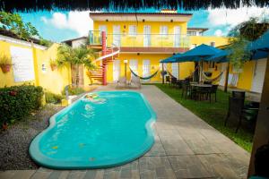 a swimming pool in the backyard of a house at Pousada Summer Beach by AFT in Porto De Galinhas +25 photos