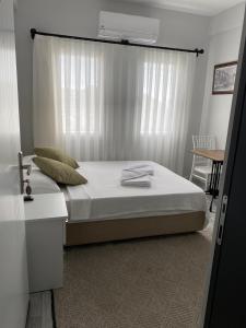 um quarto com uma cama e uma janela com um aquecedor em İZAN VİLLA BAKIŞ APARTMENTS em Bodrum City