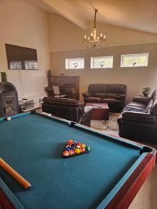 a pool table in a living room with a pool table at Montana Guest House. in Lillestrøm