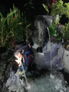 a water slide in a garden at night at ATB Hostel in Lovina