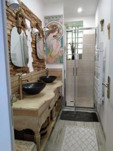 a bathroom with two sinks and a walk in shower at Bras de Mer in Cérans-Foulletourte