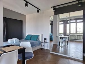 a bedroom with a bed and a table and chairs at Apartament Wiejska 9 in Warsaw