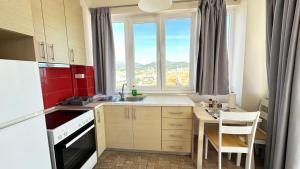a small kitchen with a sink and a window at Gorgona Di Thassos in Limenaria