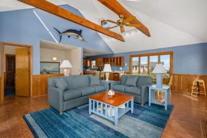 a living room with two couches and a table at DK390 Tidy Duck in Duck