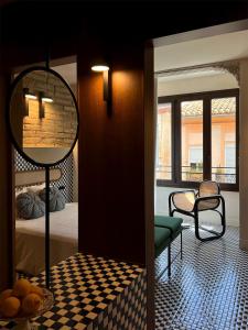 a room with a bed and a mirror and a table at El Rincón de María Vicenta in Valencia