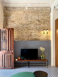 a living room with a television on a wall at El Rincón de María Vicenta in Valencia +20 photos