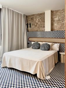 a bedroom with a bed with two pillows on it at El Rincón de María Vicenta in Valencia