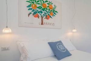 a picture of a tree with oranges on the wall at Dimore delle Zagare Molo in Syracuse