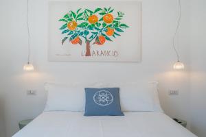 a bedroom with a bed with a picture of an orange tree at Dimore delle Zagare Molo in Syracuse