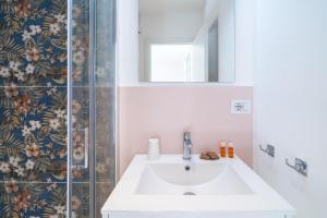 a bathroom with a sink and a mirror at Dimore delle Zagare Molo in Syracuse