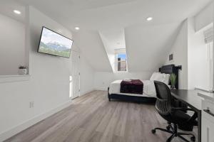 a white bedroom with a bed and a desk at New Season Royals, Airport West in Chester