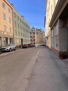 an empty street in a city with buildings at Central Helsinki Punavuori 40m2 entire flat in Helsinki