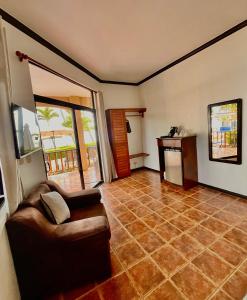 a living room with a couch and a table at The Backyard Beachfront Hotel in Jacó