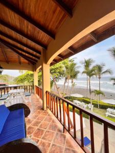 a balcony with a view of the beach at The Backyard Beachfront Hotel in Playa Hermosa +34 photos