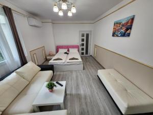 a living room with two beds and a couch at luxury two bedroom Crown Apartament in Pravets