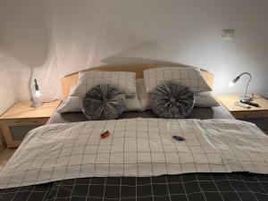 a bedroom with a large bed with two pillows at Apartments Mirjana in Piran