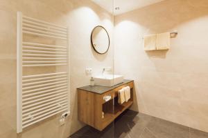 a bathroom with a sink and a mirror at Apart Himmel-Raich in Kaunertal +33 photos