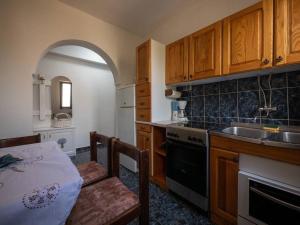 マンドレにあるQuaint 2 bedroom apartmentのキッチン(木製キャビネット、テーブル、シンク付)