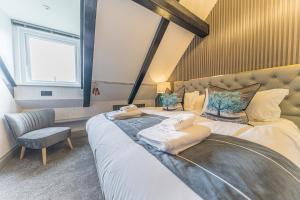 a bedroom with a large bed with towels on it at The Log House in Ambleside