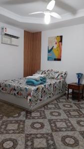 a bedroom with a bed and a ceiling fan at Casa espaçosa com Wi-Fi, garagem para 2 veículos e área externa em Campos dos Goytacazes in Campos dos Goytacazes +35 photos