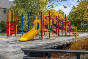 a colorful playground with a slide in a park at Tasman Holiday Parks - Christchurch in Christchurch