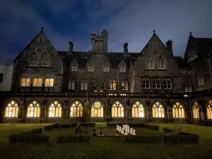 a large building with lights on the front of it at The Classrooms, Loch Ness Abbey - 142m2 Lifestyle & Heritage apartment - Pool & Spa - The Highland Club - Resort on lake shores in Fort Augustus