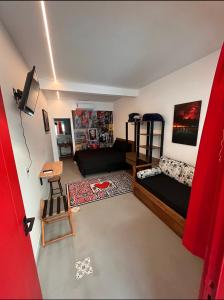 ein Wohnzimmer mit einem Bett und einem Sofa in der Unterkunft Pousada Bat N Breakfast No Beco do Batman in São Paulo