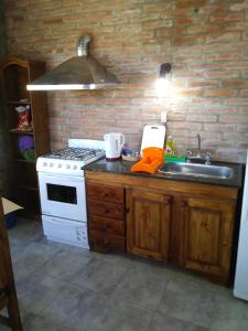 a kitchen with a stove and a sink at Bungalows Tiempo Libre in Colón