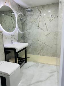 a bathroom with a sink and a shower at BANUS HAUSE Marbella in Marbella