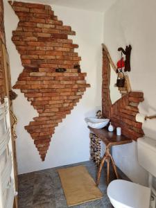 a bathroom with a wall made out of brick at Viewtopia The Secret Land in Valea Drăganului