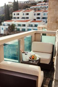 a balcony with a table with a bowl of fruit at Avala Resort & Villas in Budva