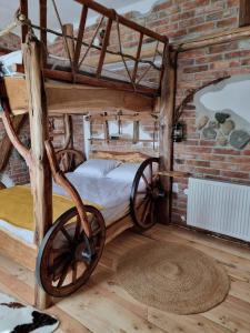 a room with two bunk beds and a brick wall at Viewtopia The Secret Land in Valea Drăganului