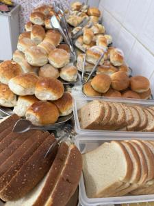 a bunch of different types of bread and pastries at Pousada Rabake in Aparecida