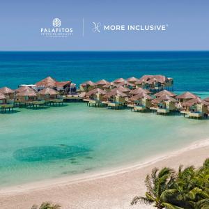 a view of a beach with overwater bungalows at Palafitos Overwater Bungalows El Dorado Maroma - Adults Only in Playa del Carmen