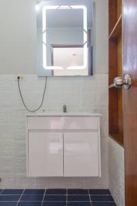 a bathroom with a white sink and a mirror at Departamento con vista en San Borja in Lima