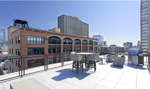 a balcony with a table and chairs on a building at McCormick Place 2br-2ba with Optional Parking, Patio, Gym access for 6 guests in Chicago