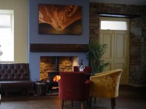 a living room with a couch and a fireplace at Anchor Hotel in Haydon Bridge