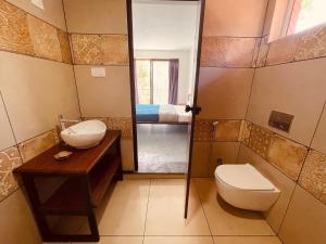 a bathroom with a toilet and a sink at Senthamarai homestay in Sultan Bathery +59 photos
