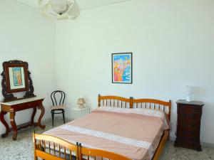 A bed or beds in a room at La Terrazza Incantata - ASCENSORE DIRETTO IN SPIAGGIA