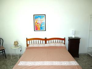 A bed or beds in a room at La Terrazza Incantata - ASCENSORE DIRETTO IN SPIAGGIA