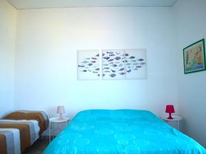 A bed or beds in a room at La Terrazza Incantata - ASCENSORE DIRETTO IN SPIAGGIA