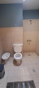 a bathroom with a toilet and a sink at Virgen de Copacabana2 in Purmamarca
