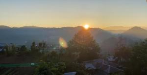 a view of the sun rising over the mountains at Aesthetic Infused with Rustic Vibe Rooms at BOONE'S in Sagada