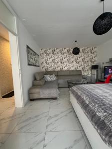 a living room with a bed and a couch at Apartman City Center 2 in Prijedor