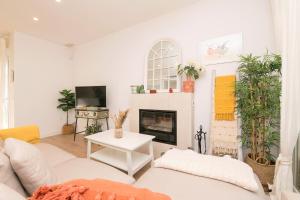 a living room with a couch and a fireplace at La Perla Costera in Chiclana de la Frontera